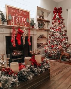 a living room decorated for christmas with red and white stockings on the fireplace mantel