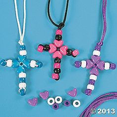 three necklaces with different designs and colors on them, one is pink, the other is blue