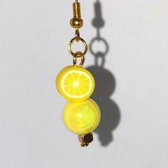 Brighten your accessory collection with these exquisite handmade dangle earrings, featuring a vibrant yellow acrylic bead with an eye-catching AB finish. The design is elevated by a delightful polymer clay lemon slice charm, adding a playful touch that is sure to turn heads. Complemented by a gold spacer bead, these earrings effortlessly blend elegance with a hint of fun. Crafted for comfort, these lightweight earrings are perfect for all-day wear, making them an ideal choice for any occasion. Whether you're dressing up for a special event or adding flair to your everyday outfit, these earrings provide the perfect pop of color. Their whimsical design makes them a standout piece that can easily enhance your personal style. Don't miss the chance to own these charming earrings from Enchanting Polymer Clay Lemon, Whimsical Polymer Clay, Handmade Dangle Earrings, Earrings Handmade Dangle, Gold Dangle Earrings, Lemon Slice, Whimsical Design, Lightweight Earrings, Everyday Outfit