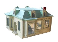 a doll house with green roof and windows