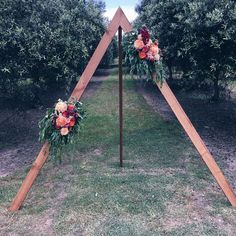 an outdoor ceremony setup with flowers and greenery