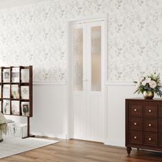 a bedroom with white walls and wooden floors