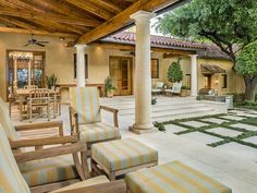 an outdoor living area with chairs and tables