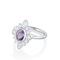 Dreamy and elegant, this compass ring features a 1.31ct oval Sri Lankan sapphire with purple hues. Bezel and shared prong set around the center are 10 round diamonds and 2 marquise diamonds. A unique engagement ring or a statement right hand ring. Complimentary resizing available for sizes 4 through 8; simply add a note with preferred size when checking out. Please note resizing this ring adds an extra 7-10 days for delivery. Purple Oval Diamond Ring, Oval Purple Diamond Ring, Lavender Diamond Oval Ring, Lavender Oval Diamond Ring, Purple Diamond Ring With Rose Cut Diamonds, Purple Oval Sapphire Ring, Brilliant Cut, Oval Purple Sapphire Ring With Diamond, Purple Oval Sapphire Ring With Brilliant Cut, Purple Brilliant Cut Oval Sapphire Ring