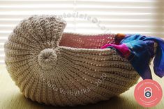 a knitted basket sitting on top of a table