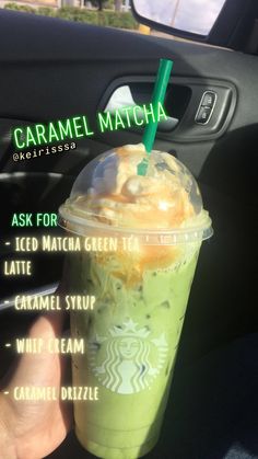 a person holding up a green drink with whipped cream on top and caramel drizzle