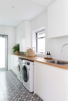 a washer and dryer in a white kitchen