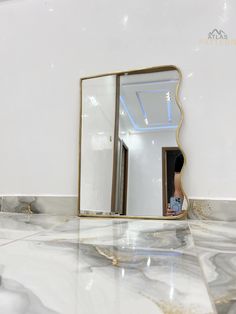 a mirror sitting on top of a marble counter