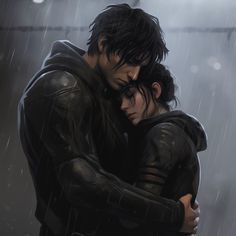 two people hugging each other in the rain