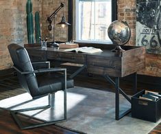 an office with a desk, chair and large clock on the brick wall behind it