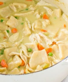 a pot filled with chicken noodle soup on top of a table