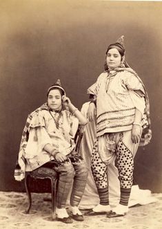 an old photo of two women in native clothing