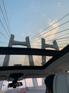 the view from inside a car looking at a bridge