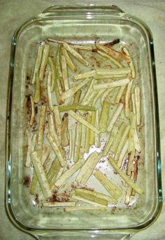 a glass dish filled with cooked green beans