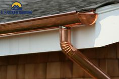 a copper colored gutter hose is attached to the side of a house's roof