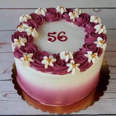 a white and pink cake with flowers on it