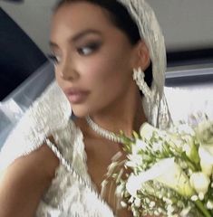 a woman in a wedding dress holding a bouquet