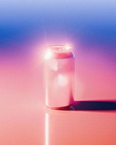 a pink and blue background with a can of soda