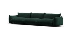 a green couch with four pillows on it's back and one arm facing the camera