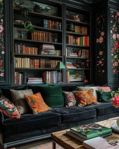 a living room filled with furniture and bookshelves covered in floral wallpapers