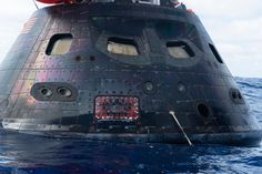 a large black object floating on top of the ocean