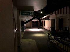 an empty hallway with a sign that says theatre 25