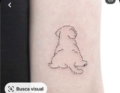 a small dog tattoo on the right arm