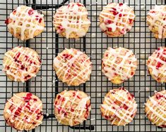 strawberry shortcakes cooling on a wire rack with icing drizzled over them