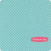 a blue and white polka dot background with a pink ribbon