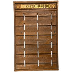 a wooden sign with holes in it that says buckle collection on the front and sides