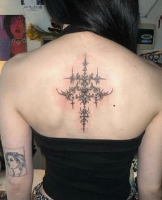 a woman with a cross tattoo on her back