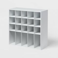 a white book shelf with several compartments on each side