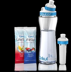 a blender and two bags of liquid next to each other on a white surface