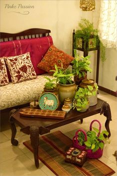 a living room filled with lots of different types of furniture and plants on top of a coffee table