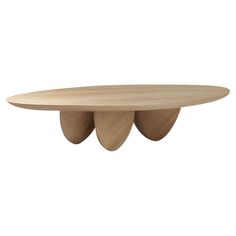 an oval wooden table with three leaves on it