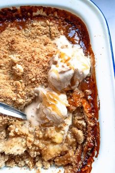 a dessert dish with ice cream and caramel sauce on the top, in a white plate