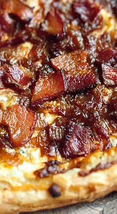 the pizza has bacon on it and is ready to be eaten