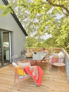 an outdoor deck with chairs and tables on it