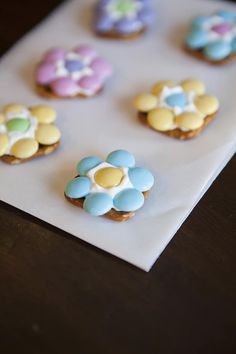 decorated cookies sitting on top of a piece of paper