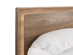 a bed with white pillows and wooden headboard on it's side, against a white background