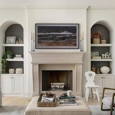 a living room filled with furniture and a fire place in front of a painting on the wall