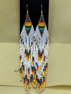 Gorgeous Long Rainbow Beaded Earrings New  Vintage Boho Natural Hippie Style  Dangling Rainbow White Gold Beads  1.25" across  7"  total length   Free Shipping White Beaded Necklaces With Dangling Beads, White Dangle Beaded Necklaces, White Beaded Necklace With Dangling Beads, Adjustable White Beaded Bracelets With Dangling Beads, White Beaded Bracelets With Dangling Beads, Traditional White Dangle Beads, White Large Beaded Dangle Earrings, White Large Beads Dangle Earrings, Multicolor Hand-strung Dangle Earrings