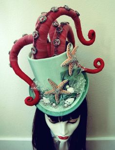 a woman with an octopus hat on top of her head and starsfishs attached to it