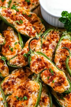 stuffed jalapeno peppers with cheese and parsley on the side, ready to be eaten