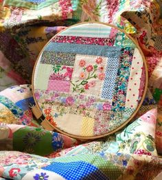 a close up of a colorful quilt with a cross stitch pattern