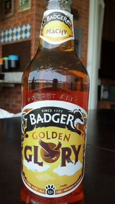 a bottle of badger's golden glory sitting on a table in front of a brick wall