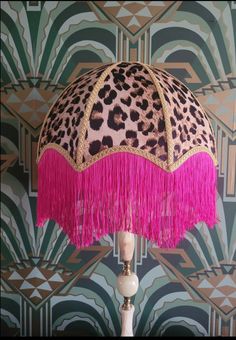 a leopard print lamp with pink fringes and a cheetah pattern on it