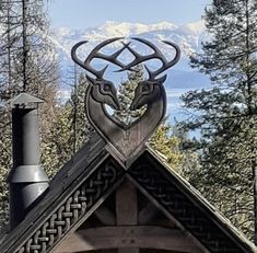 the roof of a building with a deer head and antlers on it's face