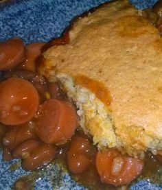 a blue plate topped with meat and beans