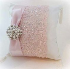 a decorative pillow with pink ribbon and pearls